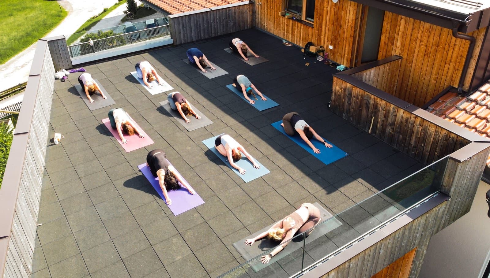 Overhead view of yoga mats laid out on the hotel rooftop deck