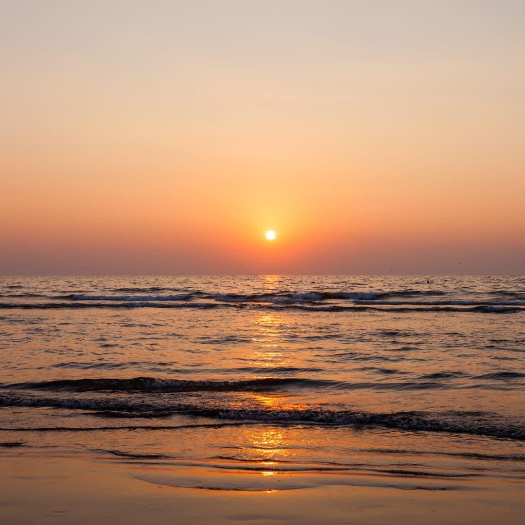 The sun setting over the sea